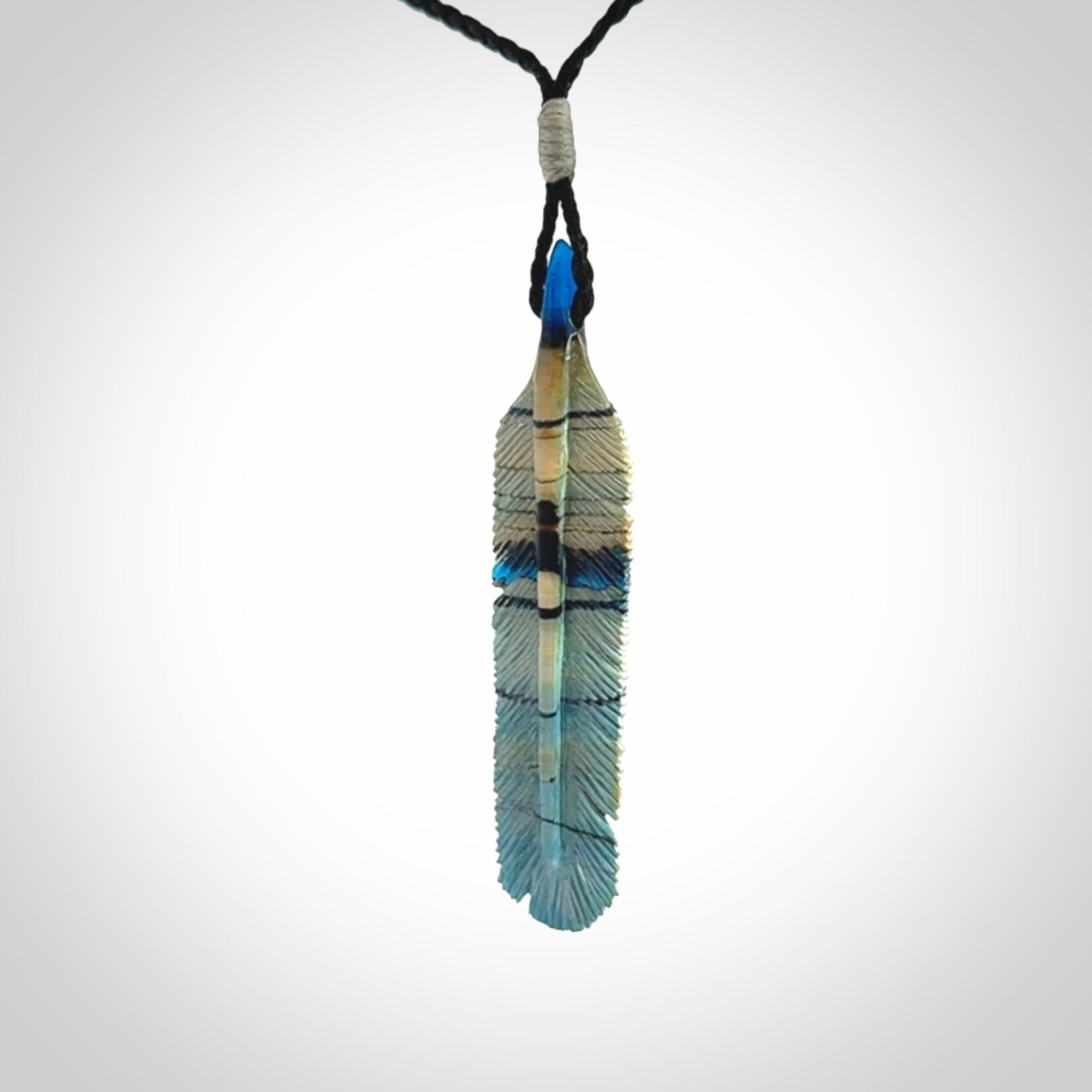 Hand carved Woolly Mammoth Tusk Blue Jay feather pendant. Hand made from Mammoth Tusk stabilised with resin. Art to Wear, one only. Provided with adjustable cord.