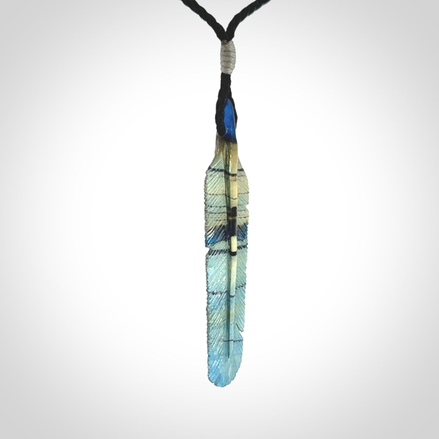 Hand carved Woolly Mammoth Tusk Blue Jay feather pendant. Hand made from Mammoth Tusk stabilised with resin. Art to Wear, one only. Provided with adjustable cord.