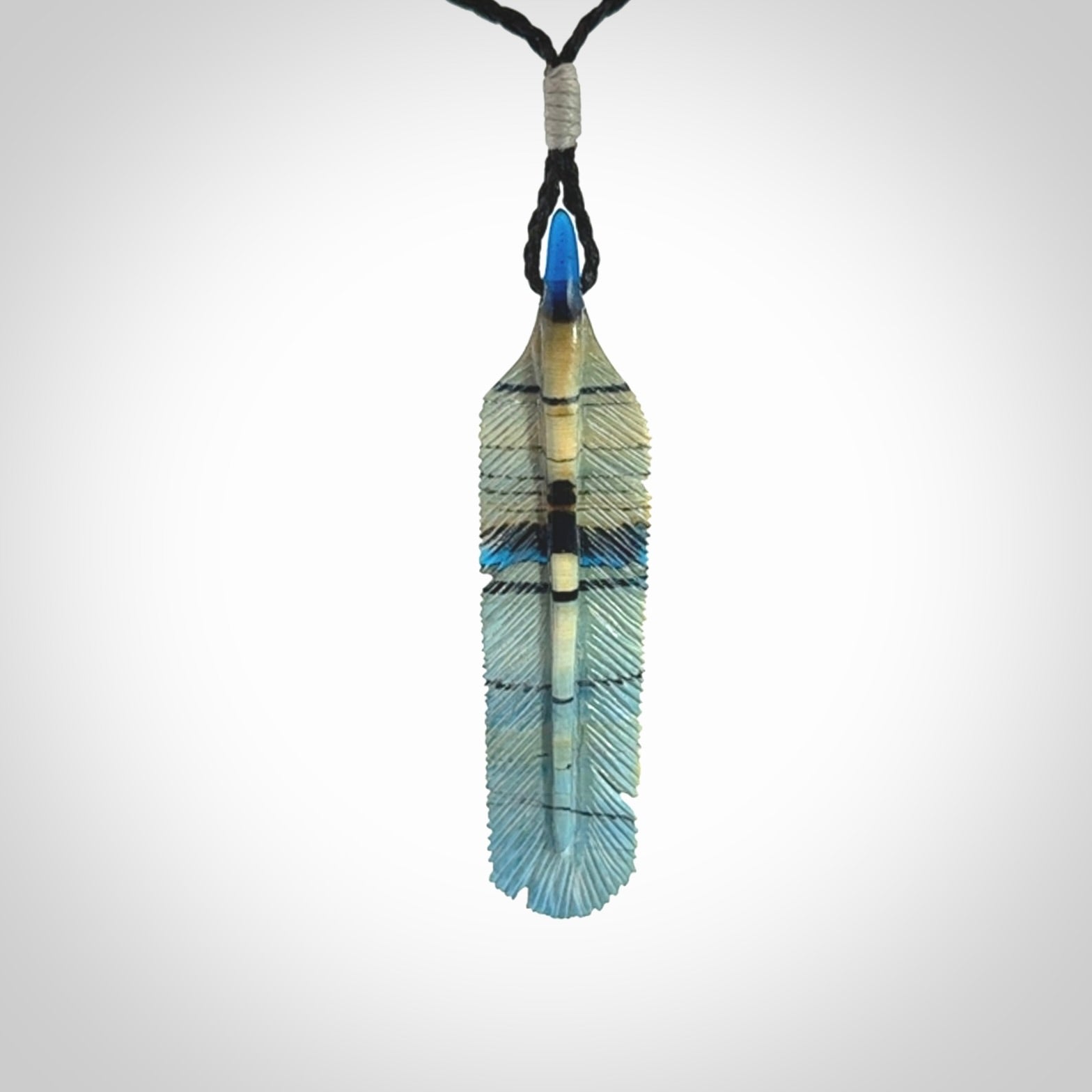 Hand carved Woolly Mammoth Tusk Blue Jay feather pendant. Hand made from Mammoth Tusk stabilised with resin. Art to Wear, one only. Provided with adjustable cord.