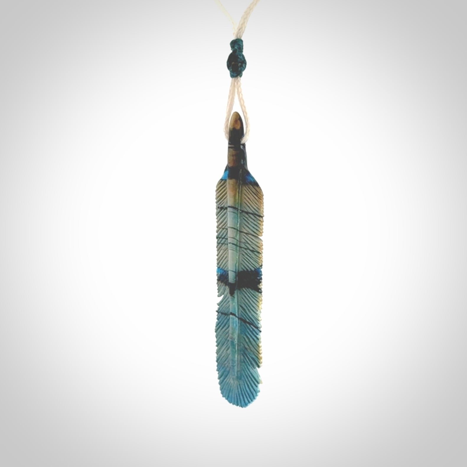 Hand carved Woolly Mammoth Tusk Blue Jay feather pendant. Hand made from Mammoth Tusk stabilised with resin. Art to Wear, one only. Provided with adjustable cord.