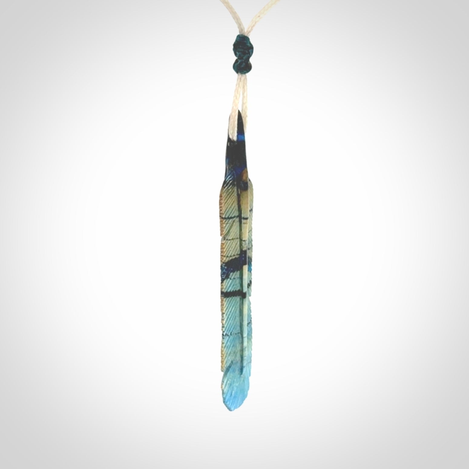 Hand carved Woolly Mammoth Tusk Blue Jay feather pendant. Hand made from Mammoth Tusk stabilised with resin. Art to Wear, one only. Provided with adjustable cord.