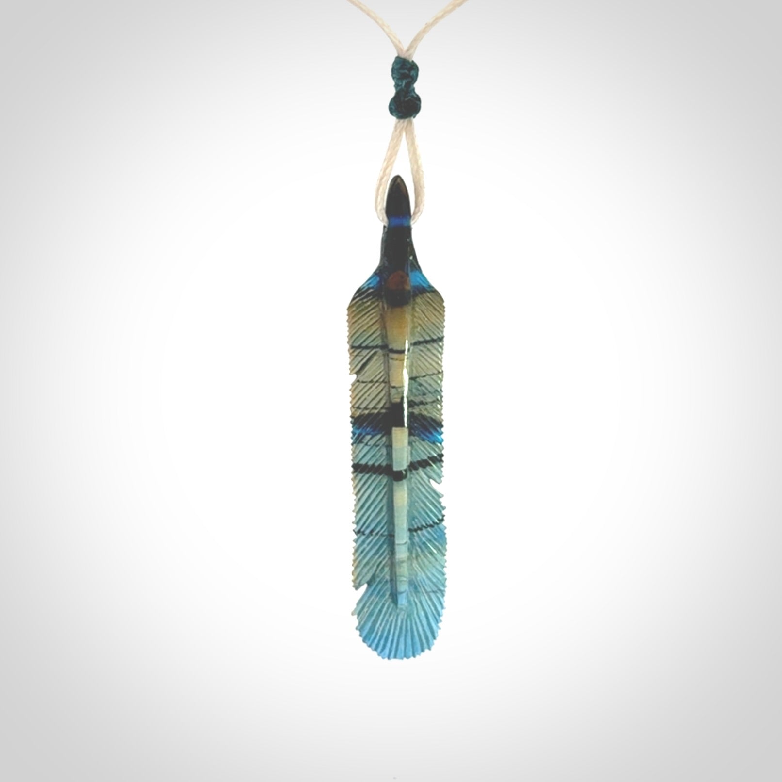 Hand carved Woolly Mammoth Tusk Blue Jay feather pendant. Hand made from Mammoth Tusk stabilised with resin. Art to Wear, one only. Provided with adjustable cord.