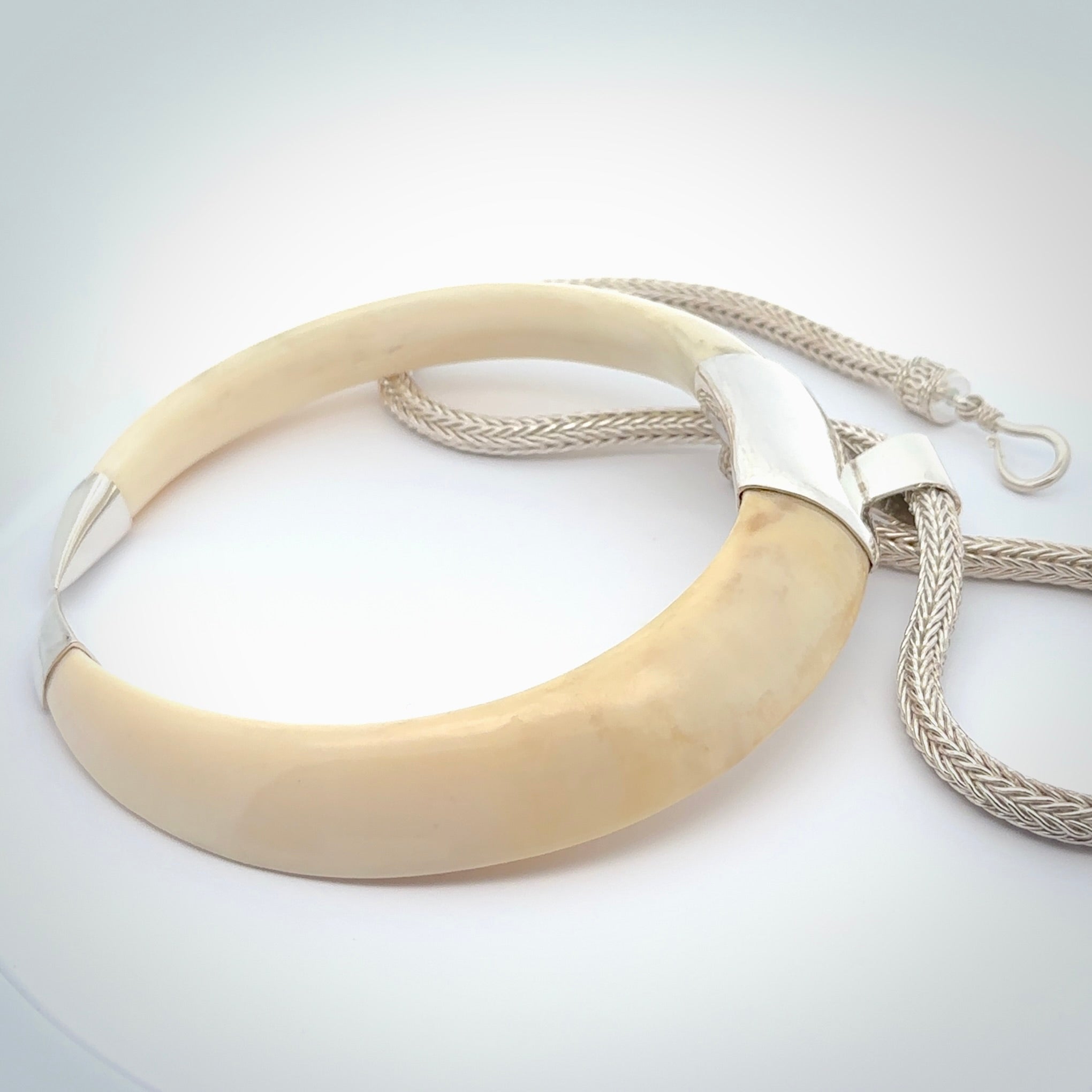 Boars Tusk Pendant with a sterling silver cap. Hand made pendant carved from a boars tusk. Hand made unique jewellery for sale by NZ Pacific online.