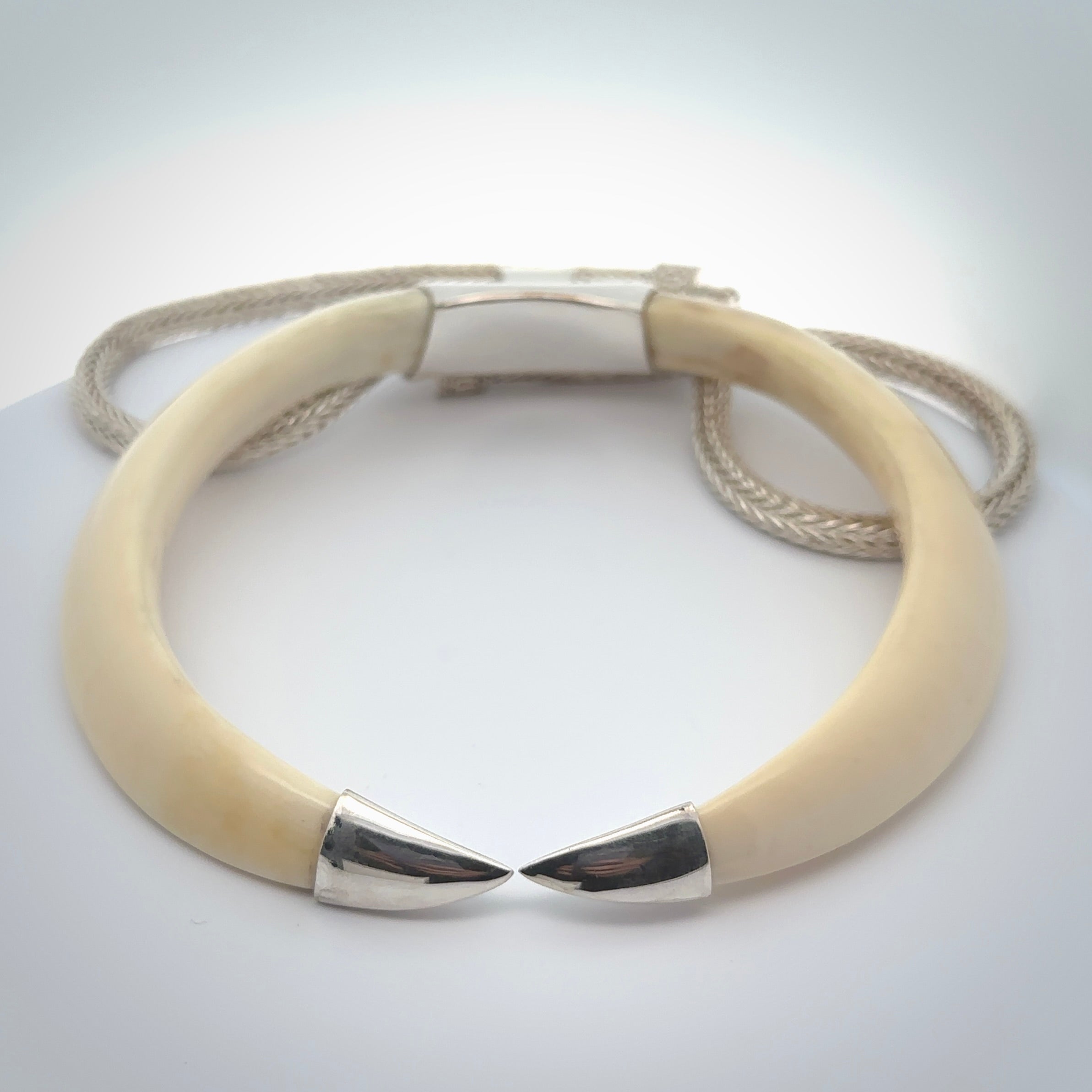 Boars Tusk Pendant with a sterling silver cap. Hand made pendant carved from a boars tusk. Hand made unique jewellery for sale by NZ Pacific online.