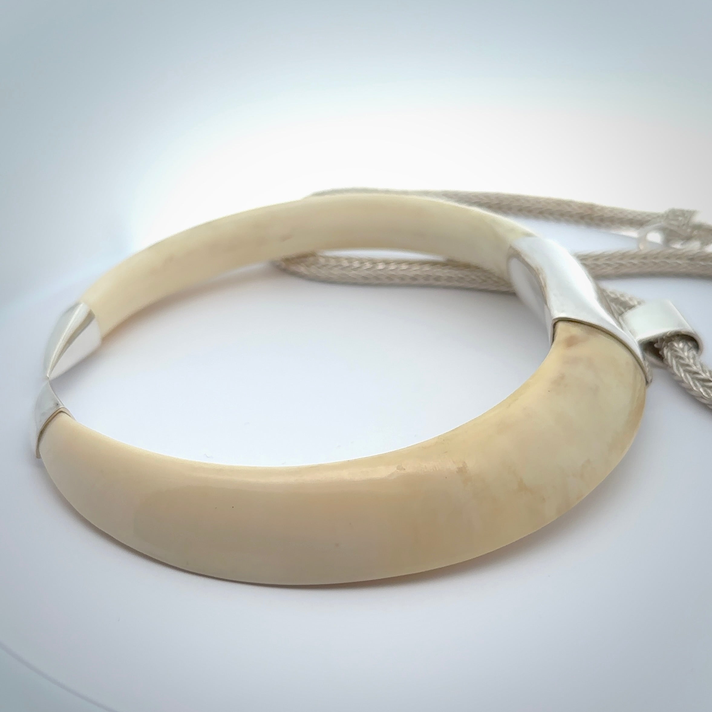 Boars Tusk Pendant with a sterling silver cap. Hand made pendant carved from a boars tusk. Hand made unique jewellery for sale by NZ Pacific online.