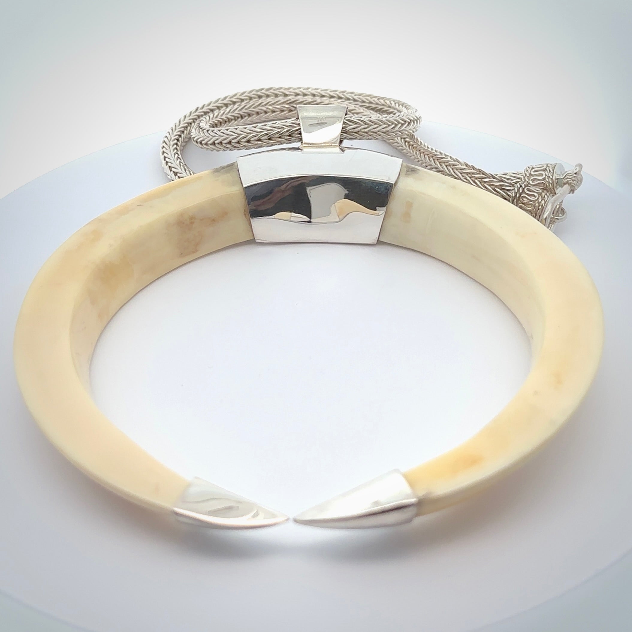 Boars Tusk Pendant with a sterling silver cap. Hand made pendant carved from a boars tusk. Hand made unique jewellery for sale by NZ Pacific online.
