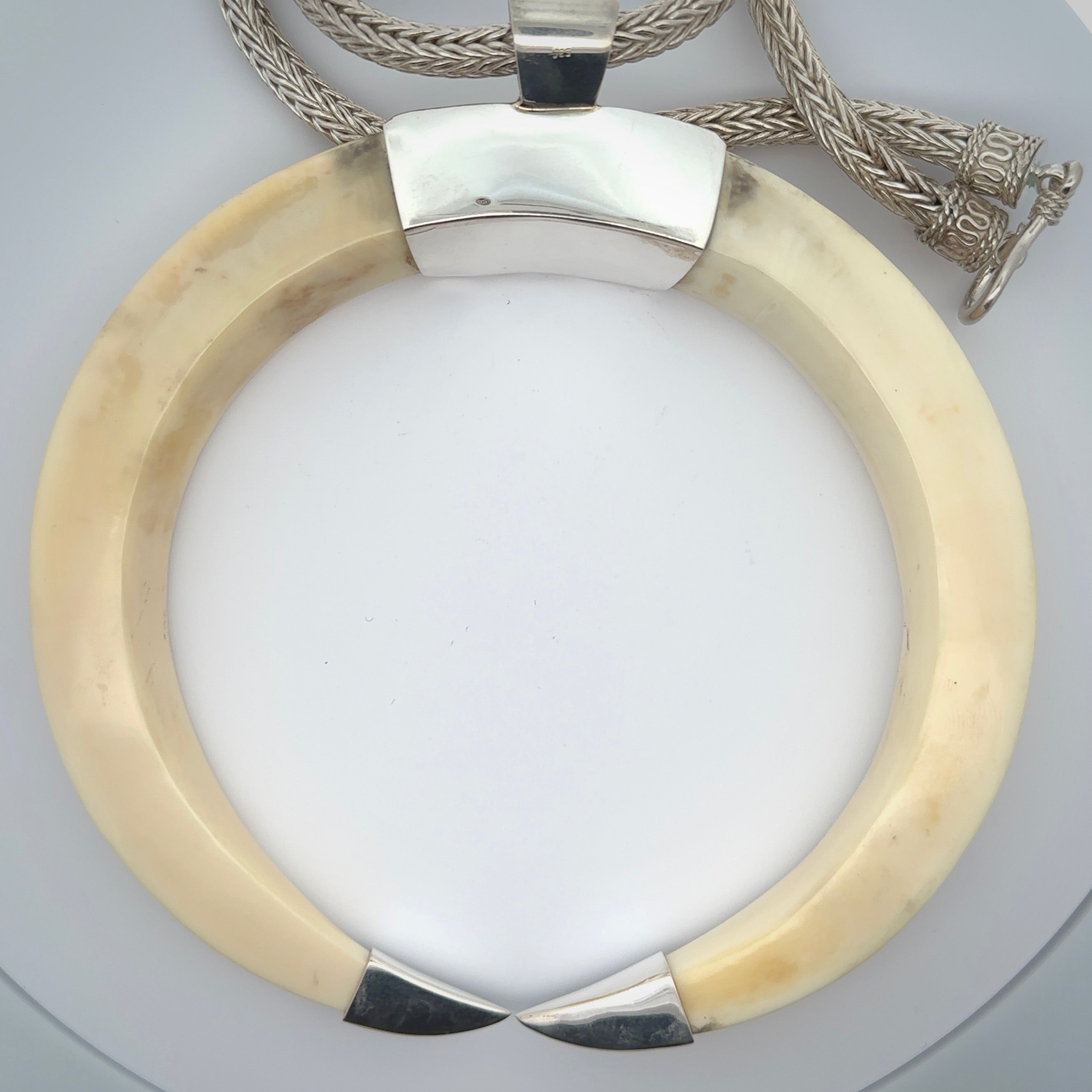 Boars Tusk Pendant with a sterling silver cap. Hand made pendant carved from a boars tusk. Hand made unique jewellery for sale by NZ Pacific online.