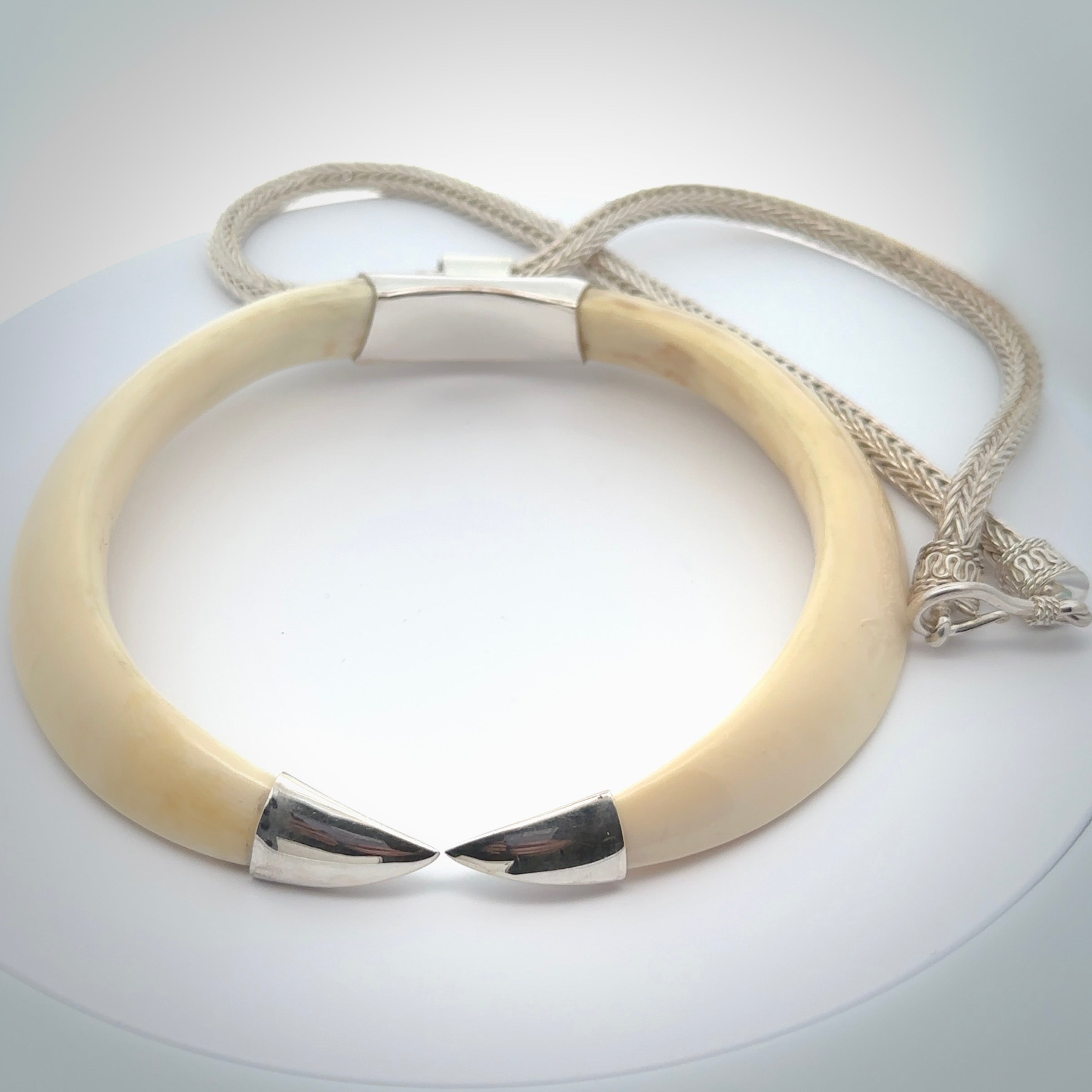 Boars Tusk Pendant with a sterling silver cap. Hand made pendant carved from a boars tusk. Hand made unique jewellery for sale by NZ Pacific online.