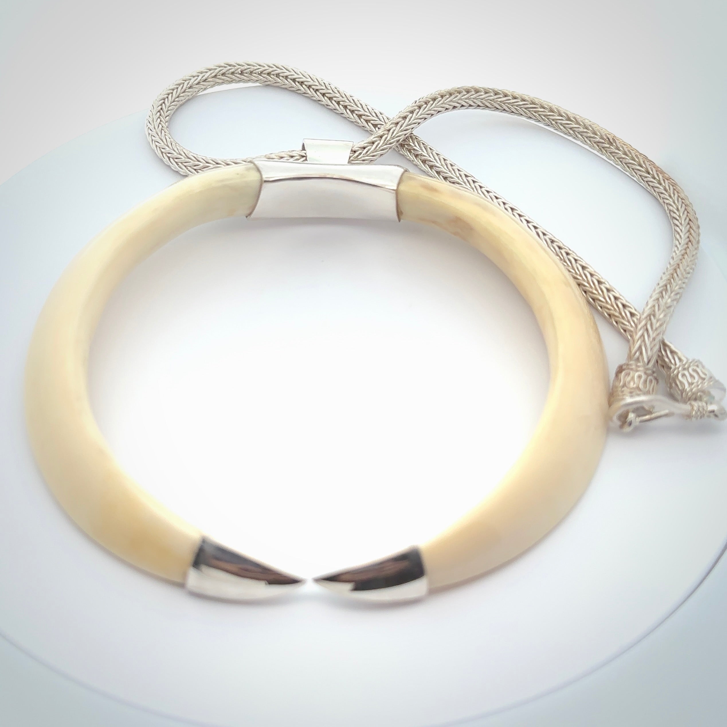 Boars Tusk Pendant with a sterling silver cap. Hand made pendant carved from a boars tusk. Hand made unique jewellery for sale by NZ Pacific online.
