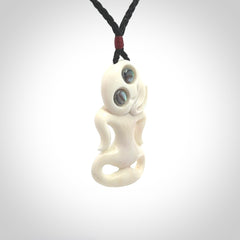 This little bone tiki has been carved to look and feel great. It has pāua shell eyes and is provided with an adjustable cord. A gorgeous and small traditional piece that is great for children.