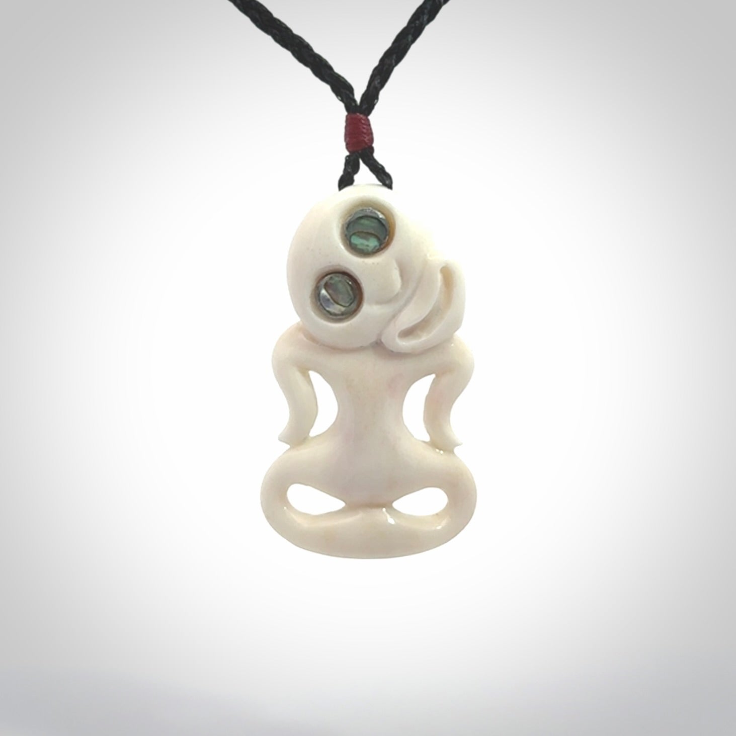 This little bone tiki has been carved to look and feel great. It has pāua shell eyes and is provided with an adjustable cord. A gorgeous and small traditional piece that is great for children.