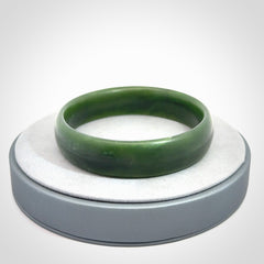 Hand carved New Zealand Jade bangle with matte finish, by Ric Moor. This is a spectacular one off, bracelet hand made in New Zealand from gorgeous Jade. Unique art to wear, delivered in a woven kete pouch. Real New Zealand Jade. Outstanding craftsmanship by New Zealand Master Carver Ric Moor.