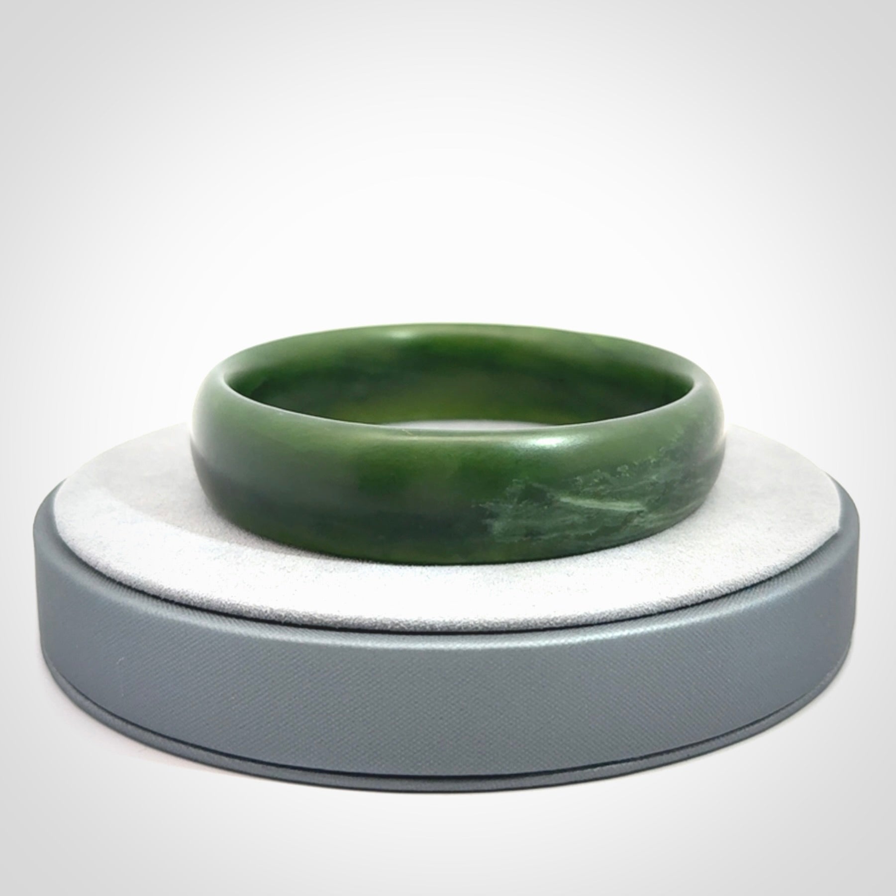 Hand carved New Zealand Jade bangle with matte finish, by Ric Moor. This is a spectacular one off, bracelet hand made in New Zealand from gorgeous Jade. Unique art to wear, delivered in a woven kete pouch. Real New Zealand Jade. Outstanding craftsmanship by New Zealand Master Carver Ric Moor.