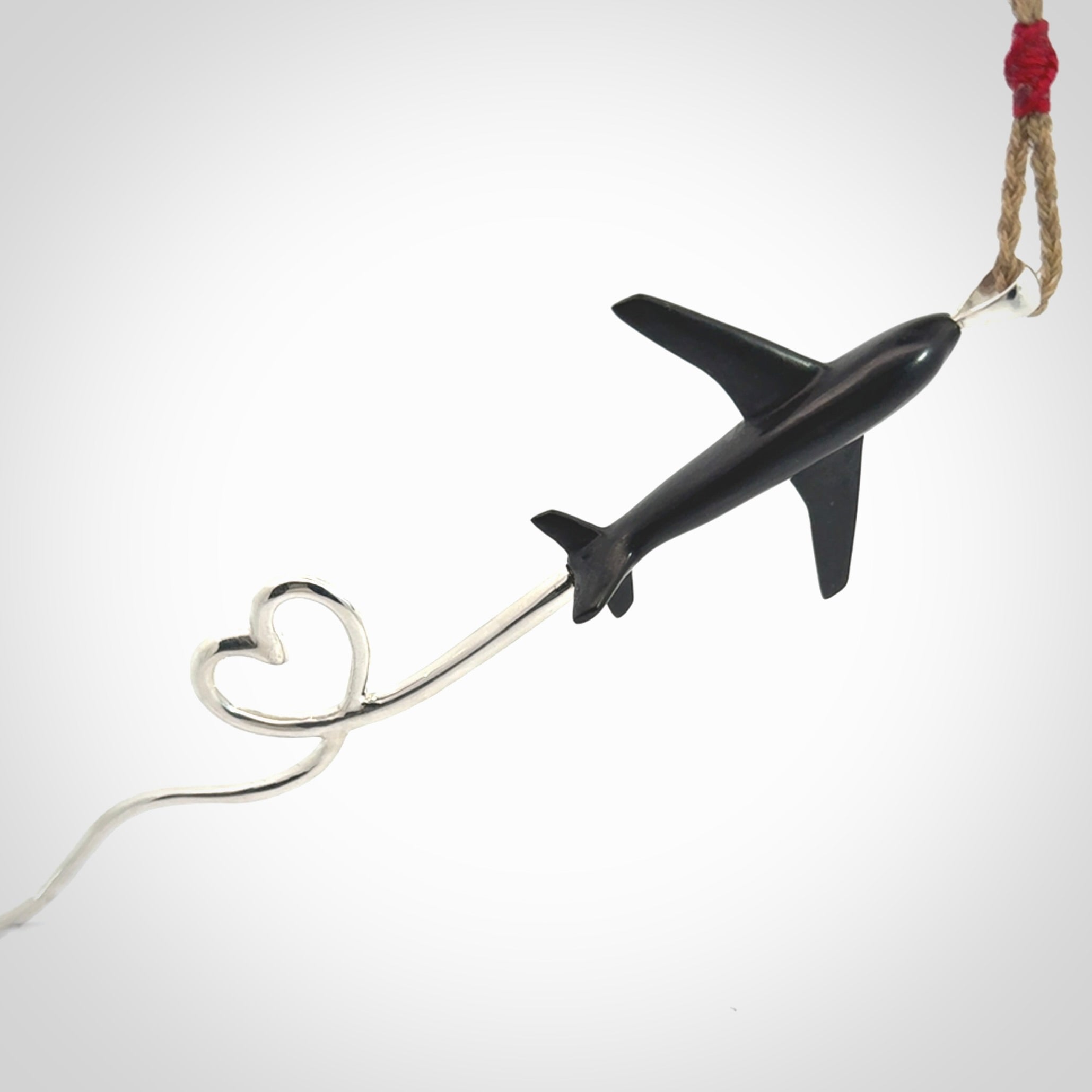 Hand carved plane and heart pendant from Australian Black Jade with Sterling Silver. This is a very cool piece of jewellery, hand made by NZ Pacific. We provide this with an adjustable cord. Free Postage Worldwide.