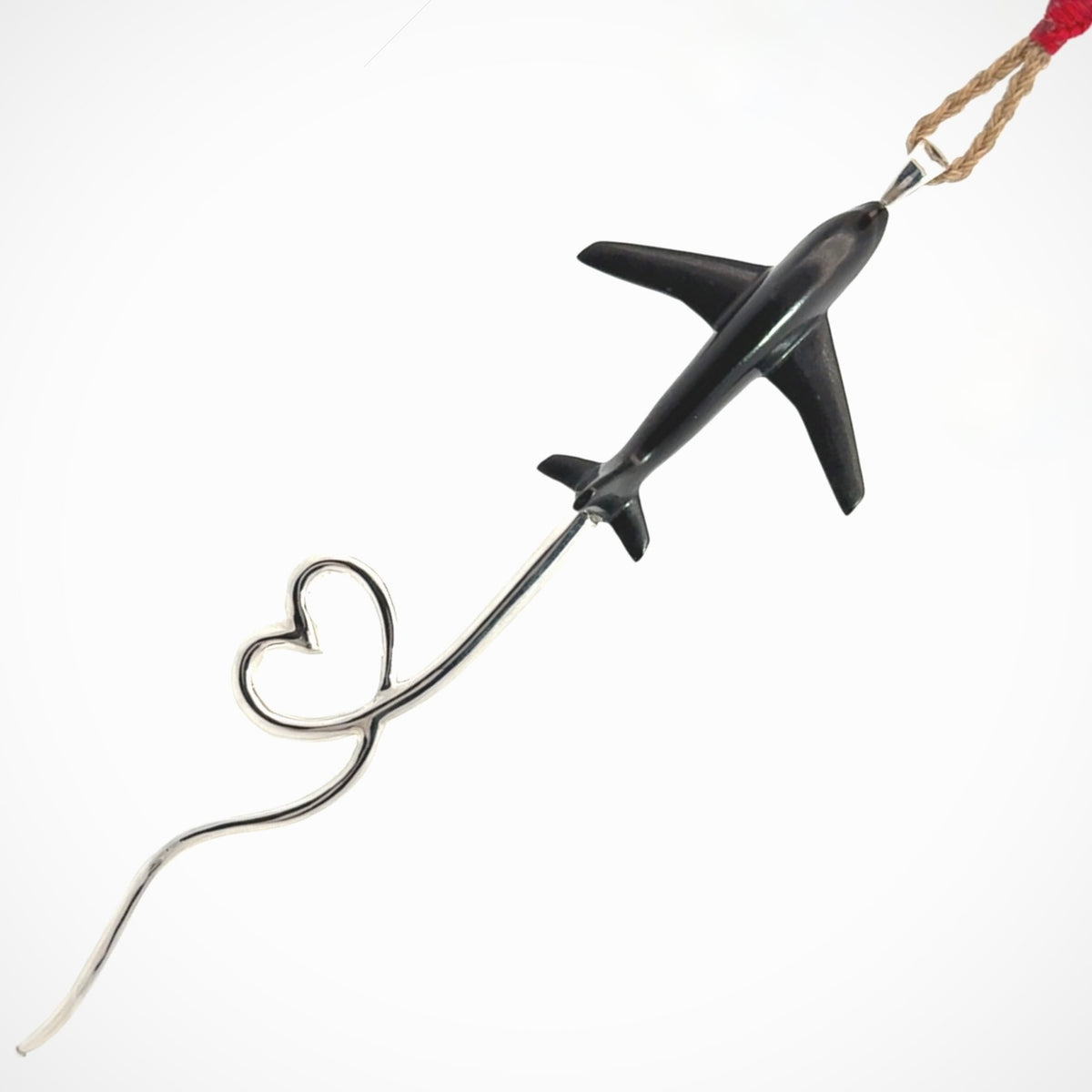 Hand carved plane and heart pendant from Australian Black Jade with Sterling Silver. This is a very cool piece of jewellery, hand made by NZ Pacific. We provide this with an adjustable cord. Free Postage Worldwide.