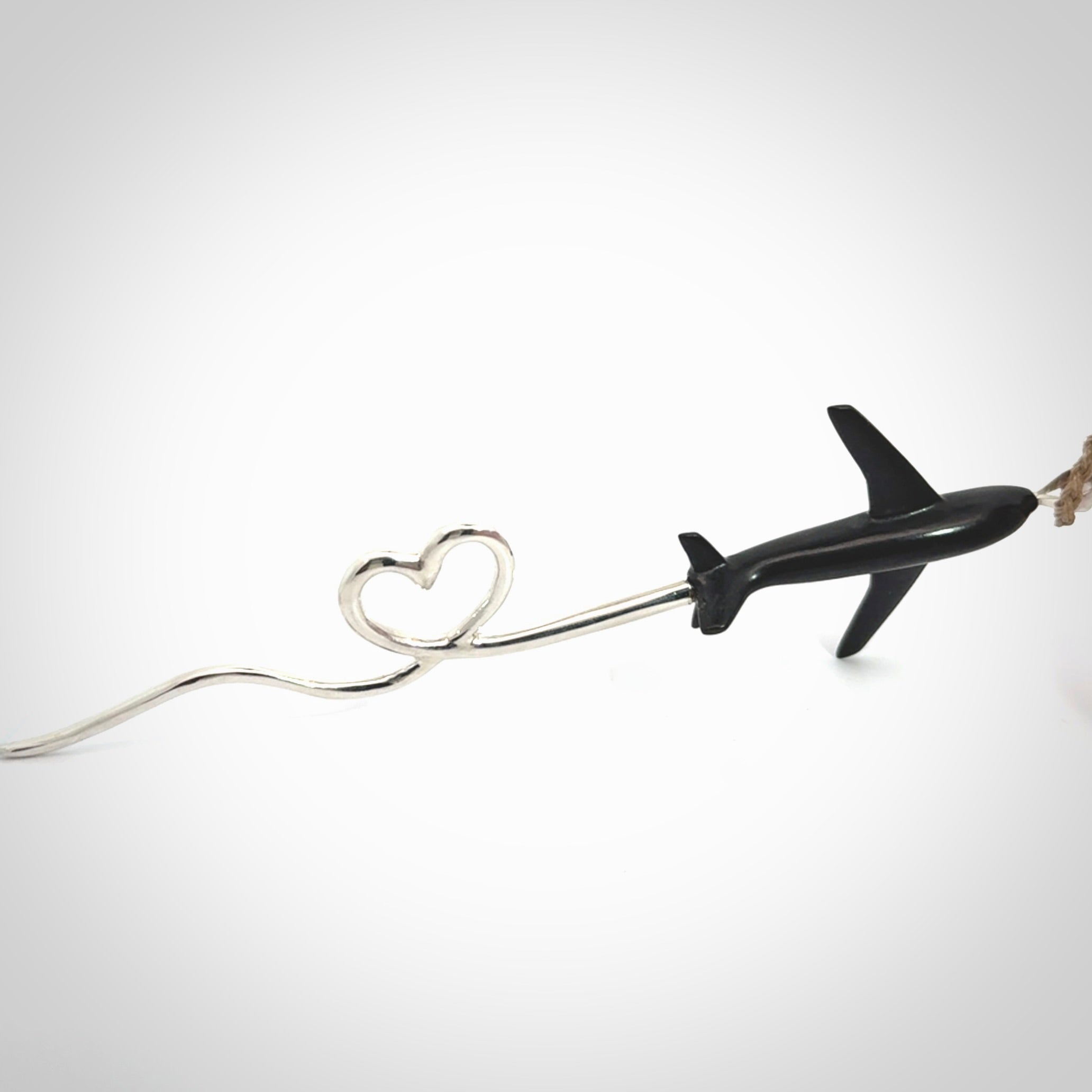 Hand carved plane and heart pendant from Australian Black Jade with Sterling Silver. This is a very cool piece of jewellery, hand made by NZ Pacific. We provide this with an adjustable cord. Free Postage Worldwide.