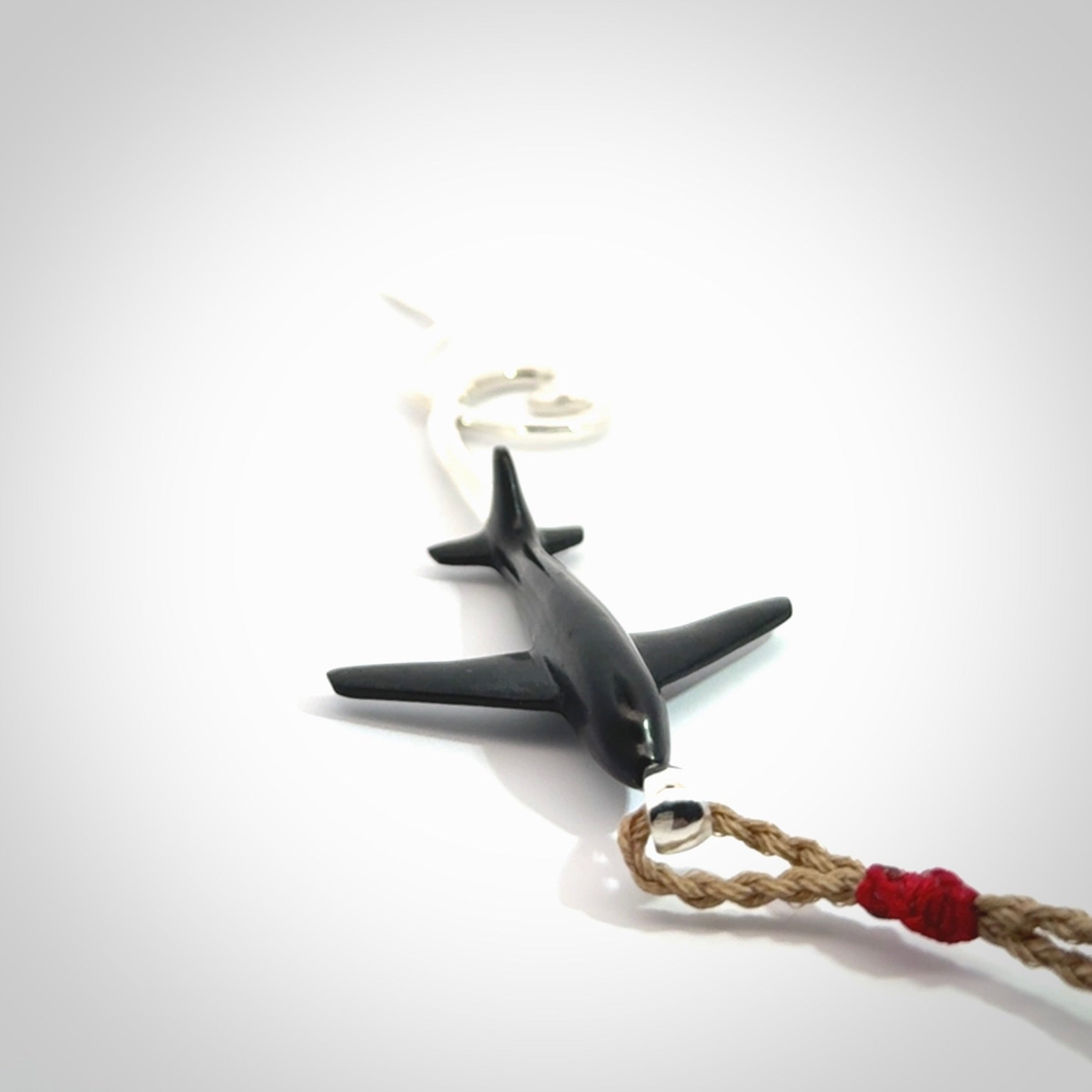 Hand carved plane and heart pendant from Australian Black Jade with Sterling Silver. This is a very cool piece of jewellery, hand made by NZ Pacific. We provide this with an adjustable cord. Free Postage Worldwide.