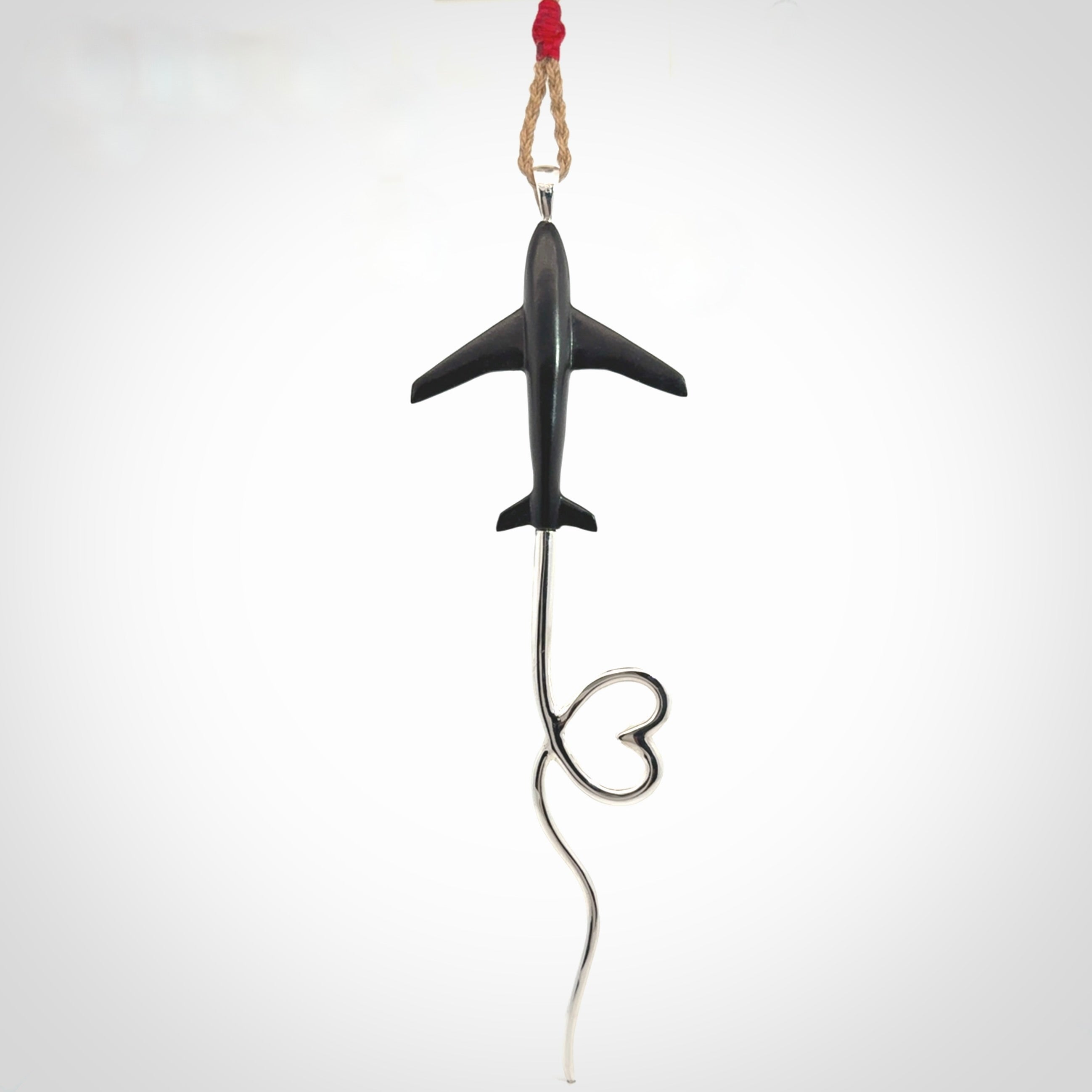 Hand carved plane and heart pendant from Australian Black Jade with Sterling Silver. This is a very cool piece of jewellery, hand made by NZ Pacific. We provide this with an adjustable cord. Free Postage Worldwide.