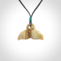 This photo shows a small whaletail pendant that we have carved from a light honey coloured piece of Woolly Mammoth tusk. It is suspended on a an adjustable cord.