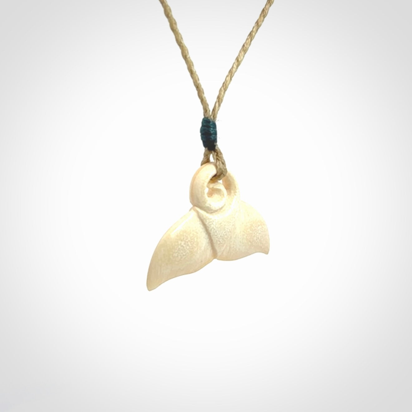 This photo shows a small whaletail pendant that we have carved from a light honey coloured piece of Woolly Mammoth tusk. It is suspended on a Safari cord that is length adjustable.