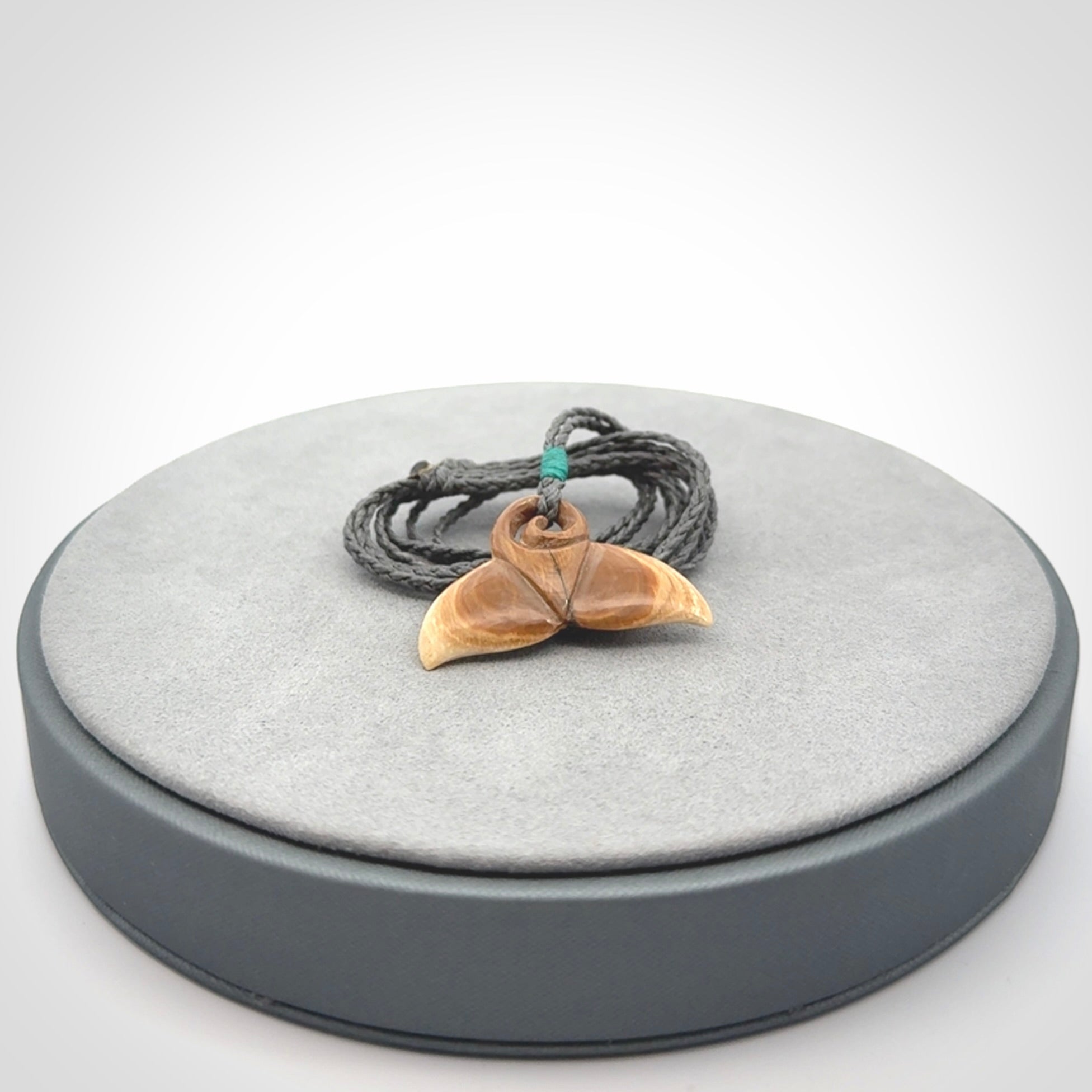 This photo shows a small whaletail pendant that we have carved from a light honey coloured piece of Woolly Mammoth tusk. It is suspended on a an adjustable cord.