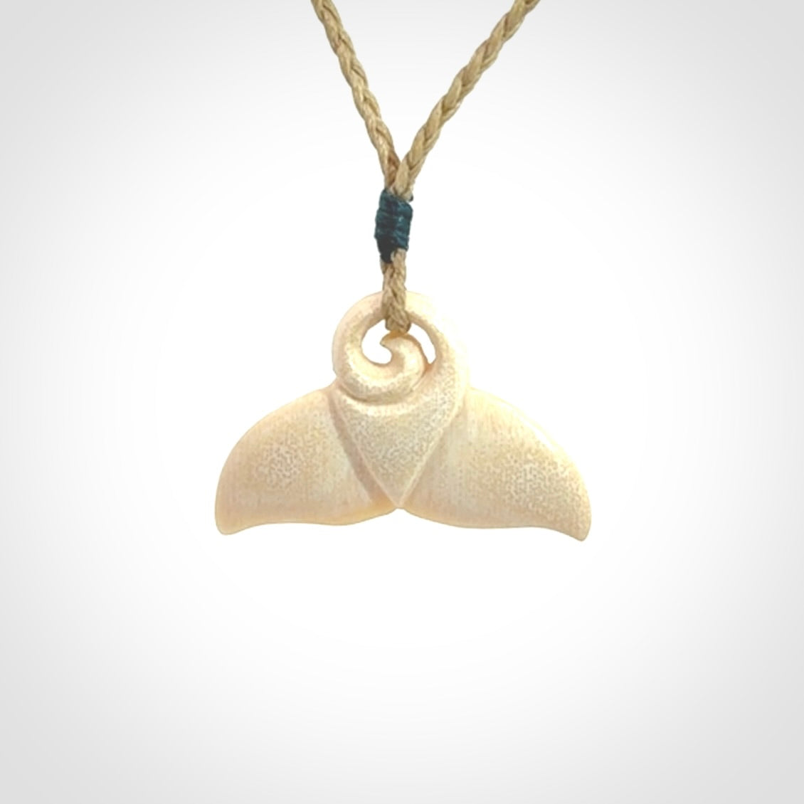 This photo shows a small whaletail pendant that we have carved from a light honey coloured piece of Woolly Mammoth tusk. It is suspended on a Safari cord that is length adjustable.