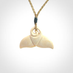 This photo shows a small whaletail pendant that we have carved from a light honey coloured piece of Woolly Mammoth tusk. It is suspended on a Safari cord that is length adjustable.