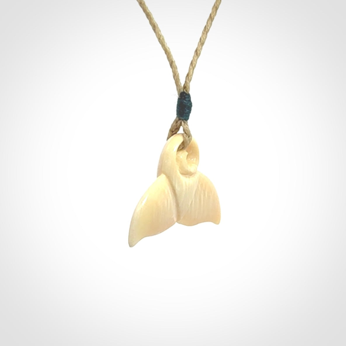This photo shows a small whaletail pendant that we have carved from a light honey coloured piece of Woolly Mammoth tusk. It is suspended on a Safari cord that is length adjustable.