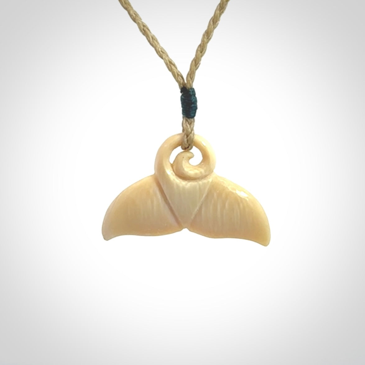 This photo shows a small whaletail pendant that we have carved from a light honey coloured piece of Woolly Mammoth tusk. It is suspended on a Safari cord that is length adjustable.