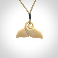 This photo shows a small whaletail pendant that we have carved from a light honey coloured piece of Woolly Mammoth tusk. It is suspended on a Safari cord that is length adjustable.