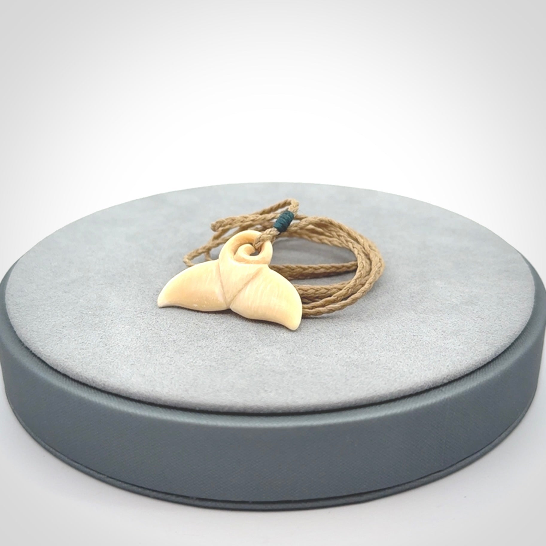 This photo shows a small whaletail pendant that we have carved from a light honey coloured piece of Woolly Mammoth tusk. It is suspended on a Safari cord that is length adjustable.