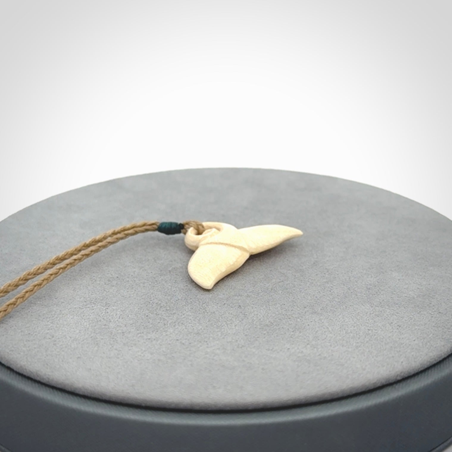 This photo shows a small whaletail pendant that we have carved from a light honey coloured piece of Woolly Mammoth tusk. It is suspended on a Safari cord that is length adjustable.