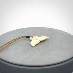 This photo shows a small whaletail pendant that we have carved from a light honey coloured piece of Woolly Mammoth tusk. It is suspended on a Safari cord that is length adjustable.