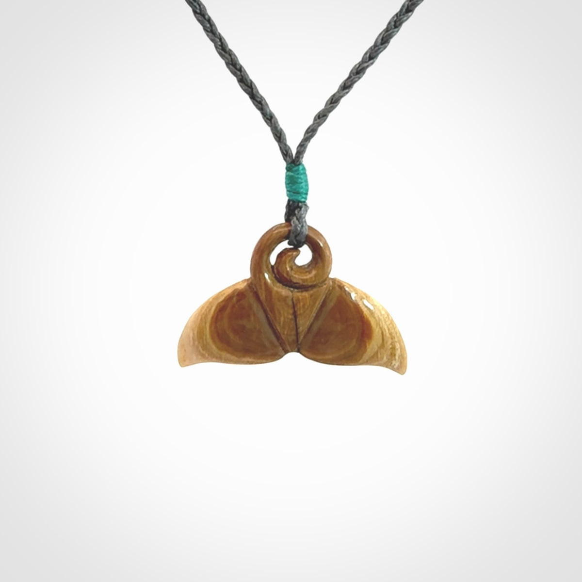 This photo shows a small whaletail pendant that we have carved from a light honey coloured piece of Woolly Mammoth tusk. It is suspended on a an adjustable cord.