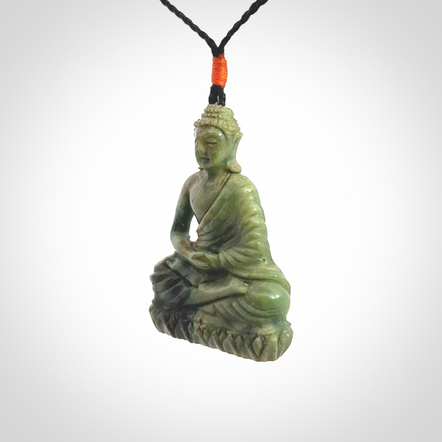 This photo shows a Buddha pendant hand carved in Jade. It is provided with an adjustable cord.