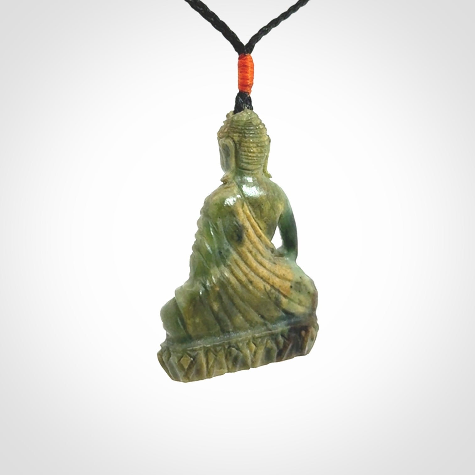 This photo shows a Buddha pendant hand carved in Jade. It is provided with an adjustable cord.