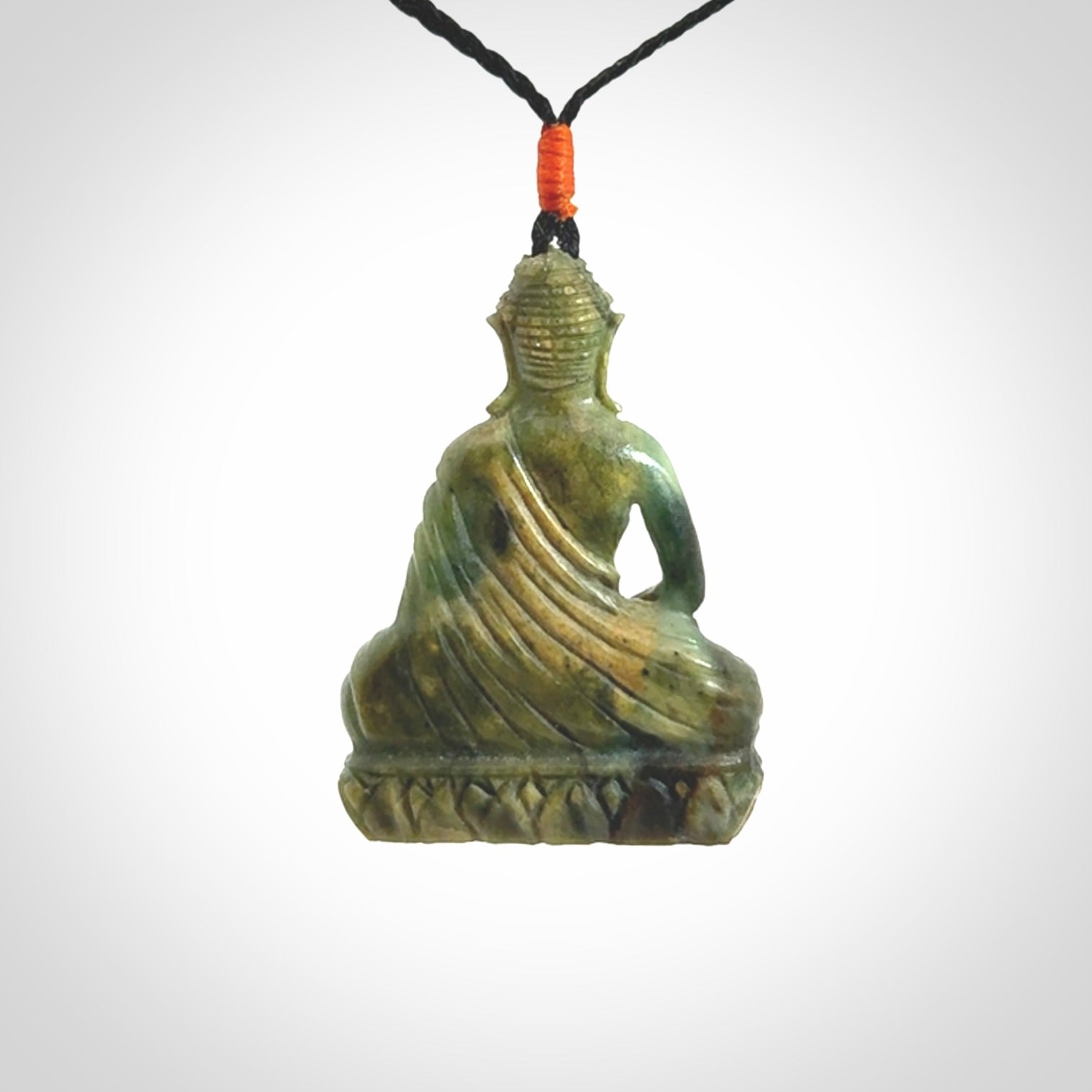 This photo shows a Buddha pendant hand carved in Jade. It is provided with an adjustable cord.