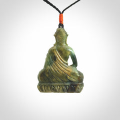 This photo shows a Buddha pendant hand carved in Jade. It is provided with an adjustable cord.