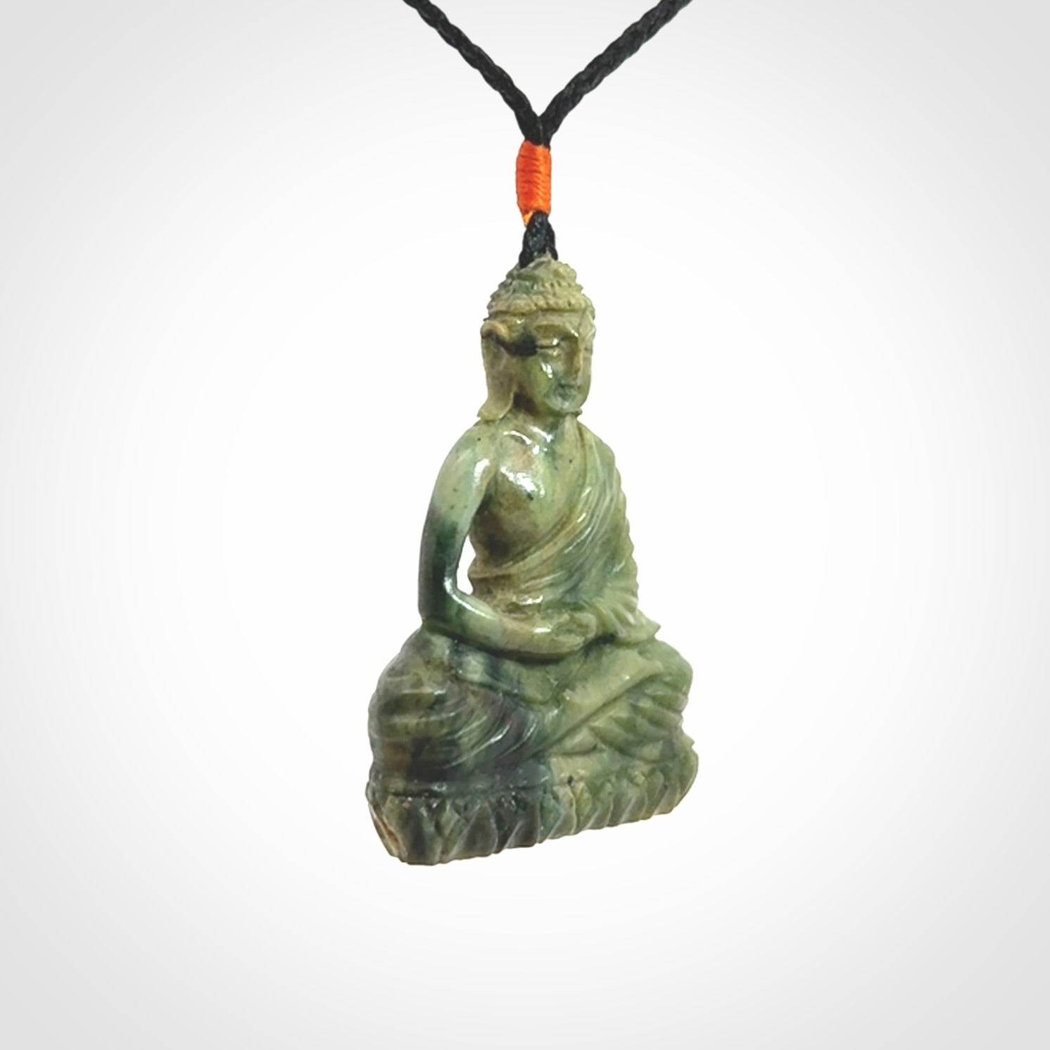 This photo shows a Buddha pendant hand carved in Jade. It is provided with an adjustable cord.