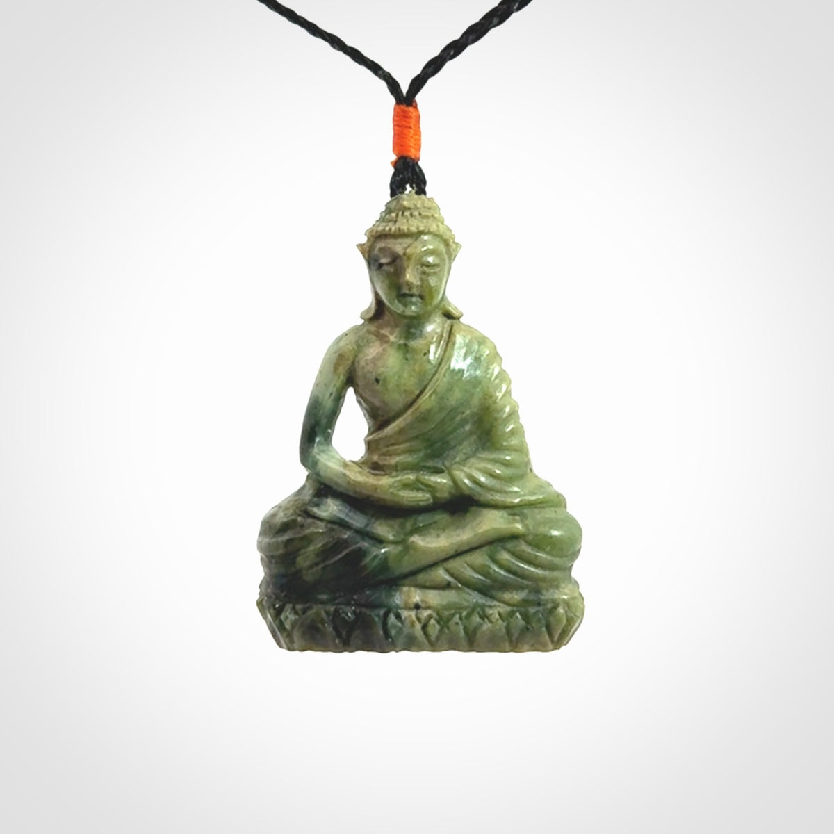 This photo shows a Buddha pendant hand carved in Jade. It is provided with an adjustable cord.