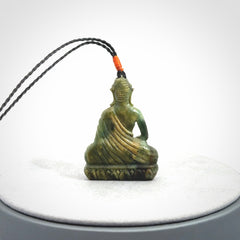 This photo shows a Buddha pendant hand carved in Jade. It is provided with an adjustable cord.