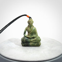 This photo shows a Buddha pendant hand carved in Jade. It is provided with an adjustable cord.