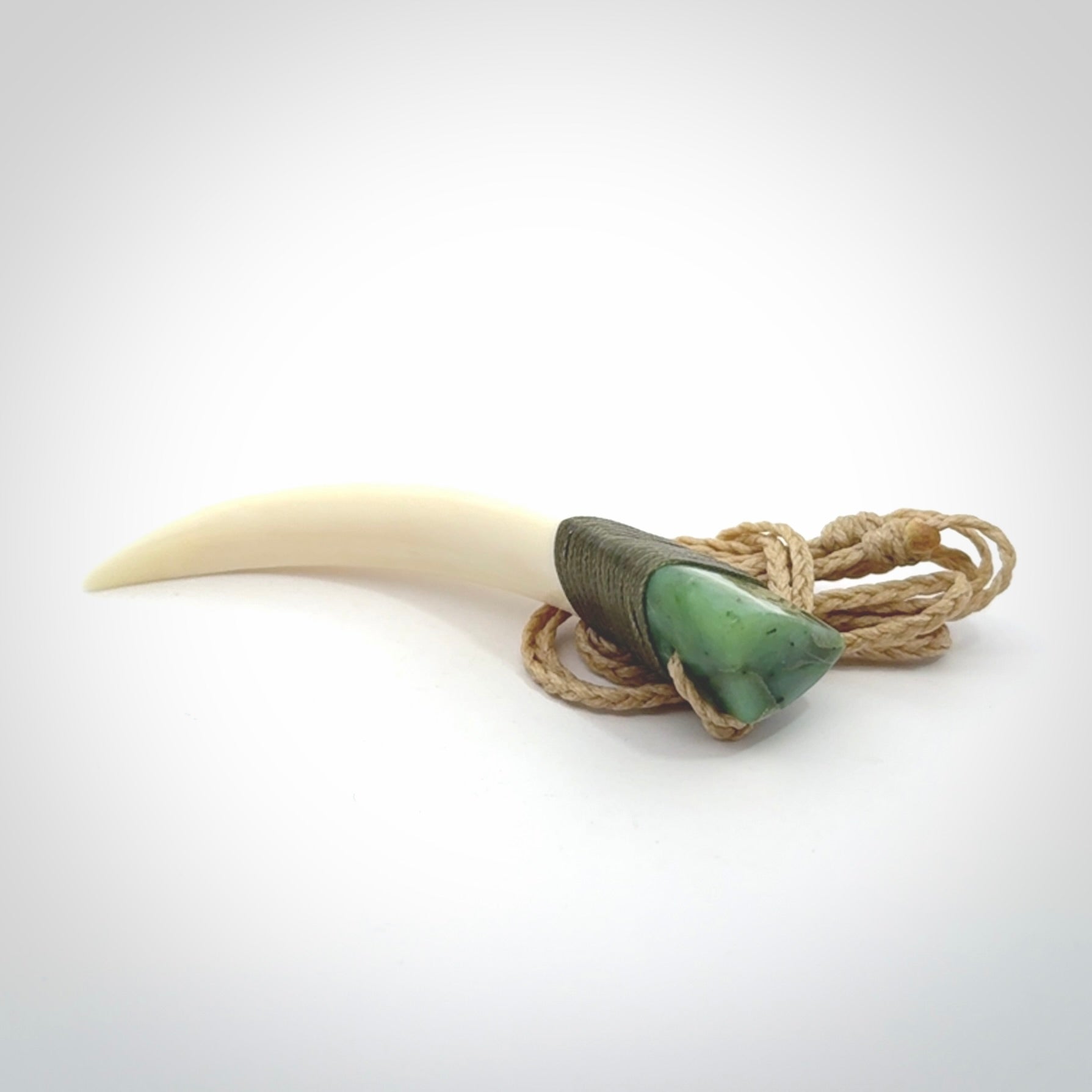 Boars Tusk Pendant with a jade cap. Hand made pendant carved from a boars tusk.