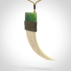 Boars Tusk Pendant with a jade cap. Hand made pendant carved from a boars tusk.