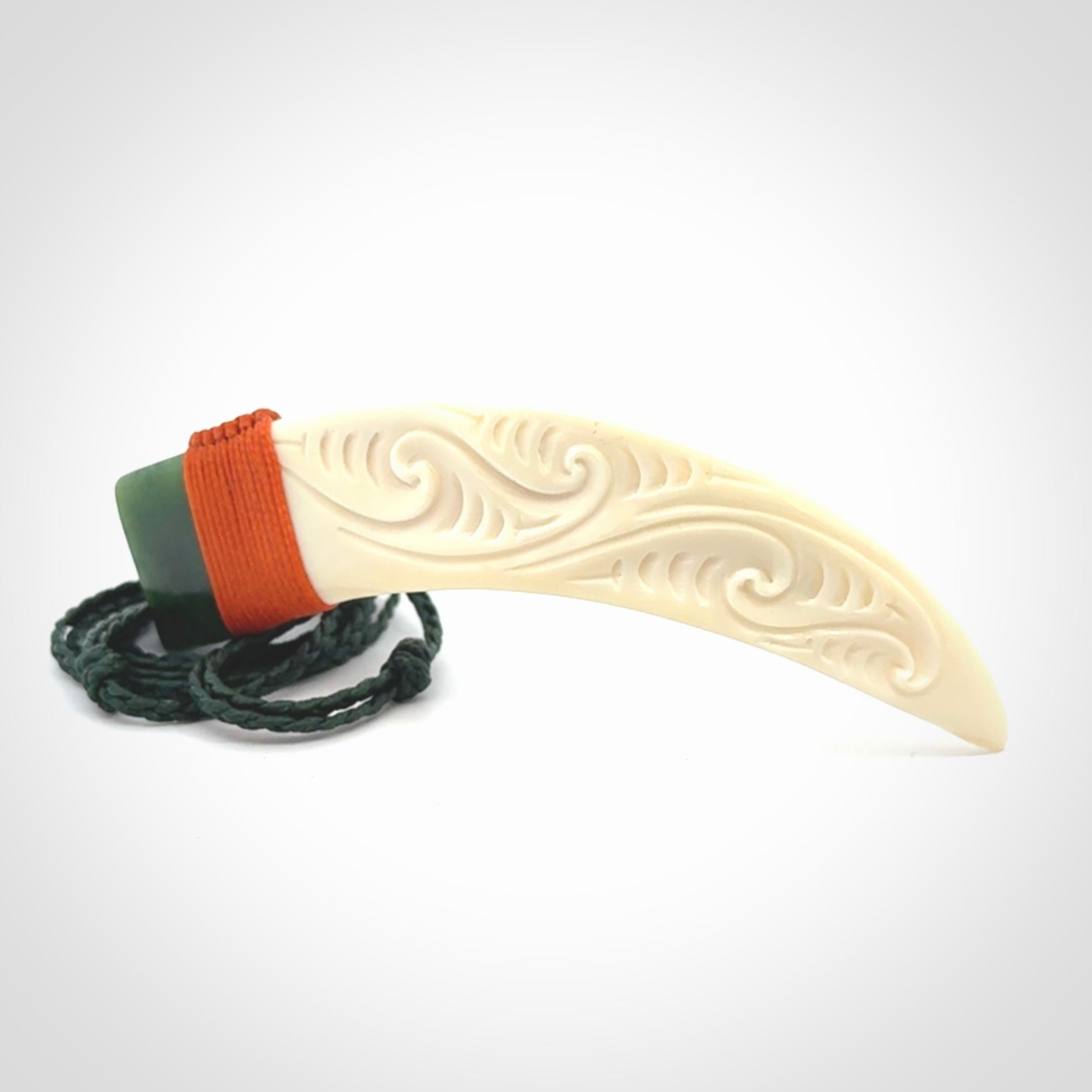 Boars Tusk Pendant with a jade cap. Hand made pendant carved from a boars tusk.