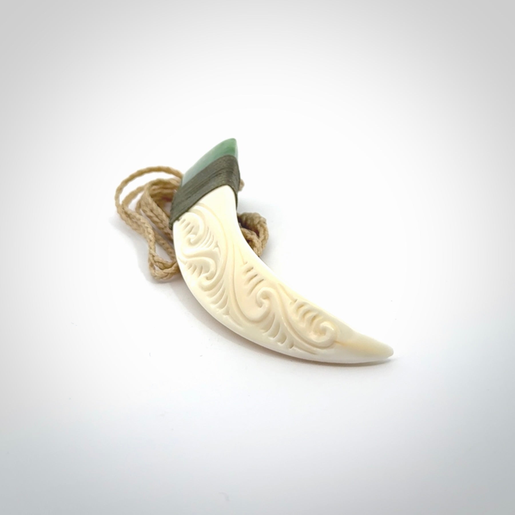 Boars Tusk Pendant with a jade cap. Hand made pendant carved from a boars tusk.