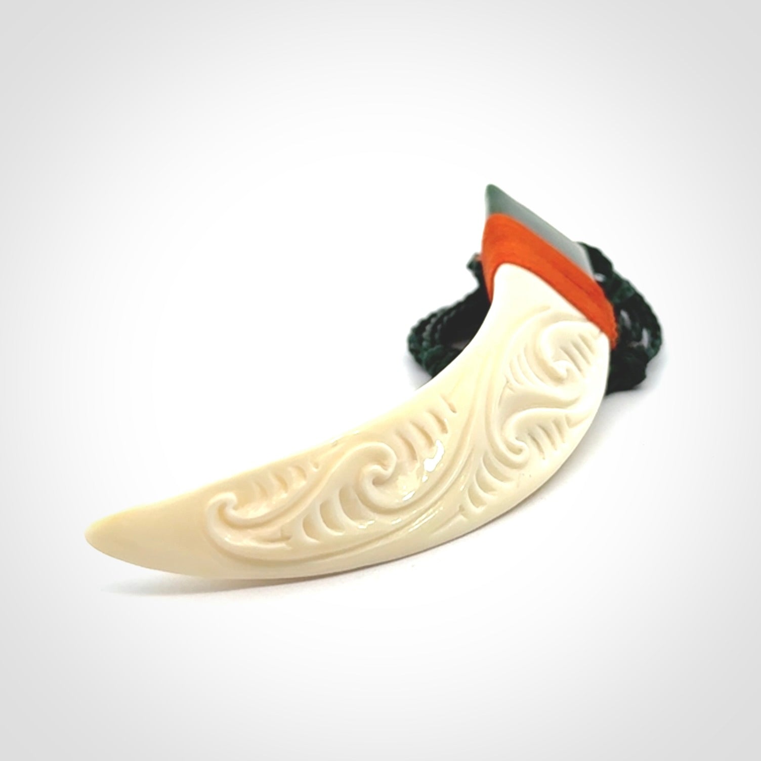 Boars Tusk Pendant with a jade cap. Hand made pendant carved from a boars tusk.