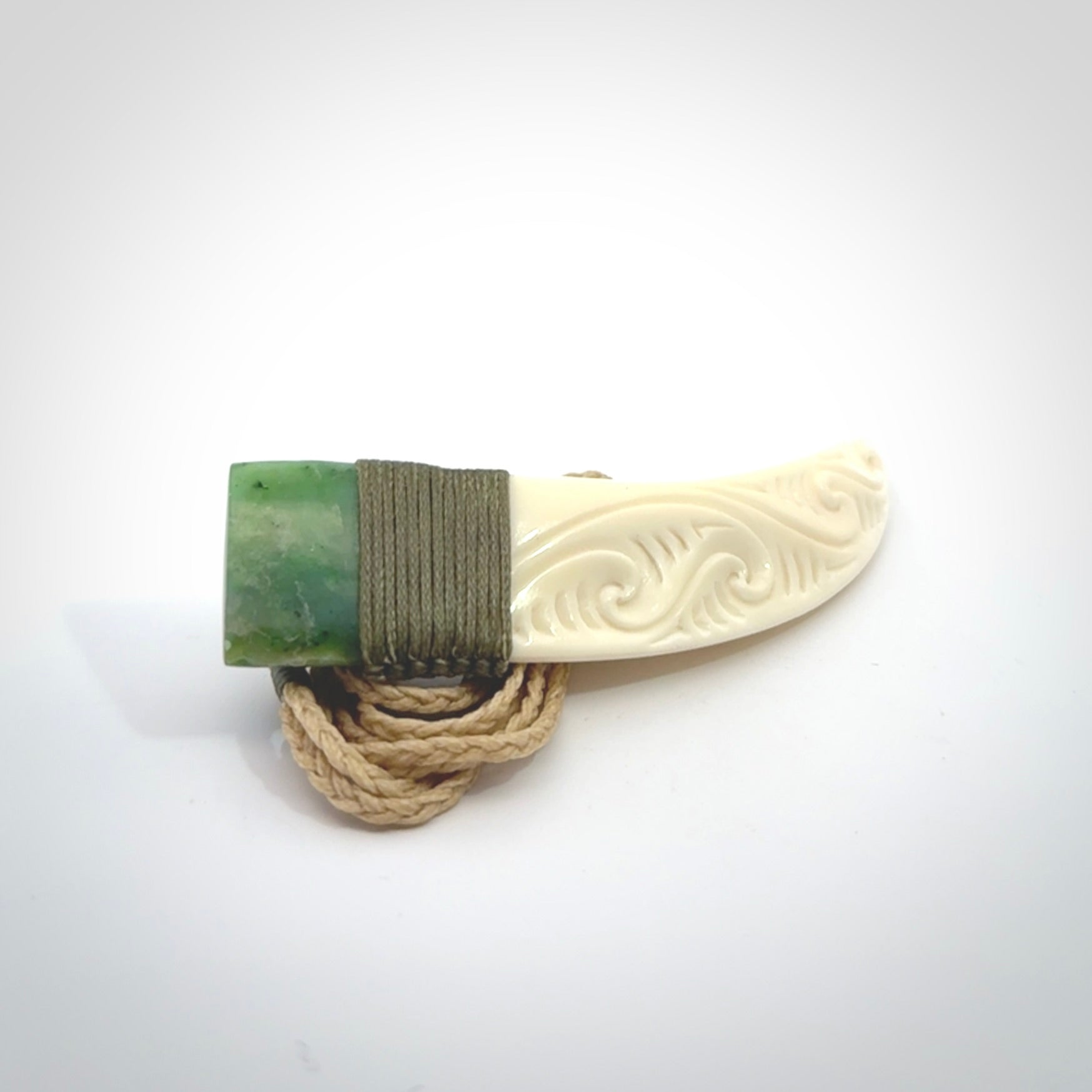 Boars Tusk Pendant with a jade cap. Hand made pendant carved from a boars tusk.