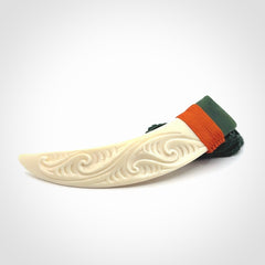 Boars Tusk Pendant with a jade cap. Hand made pendant carved from a boars tusk.