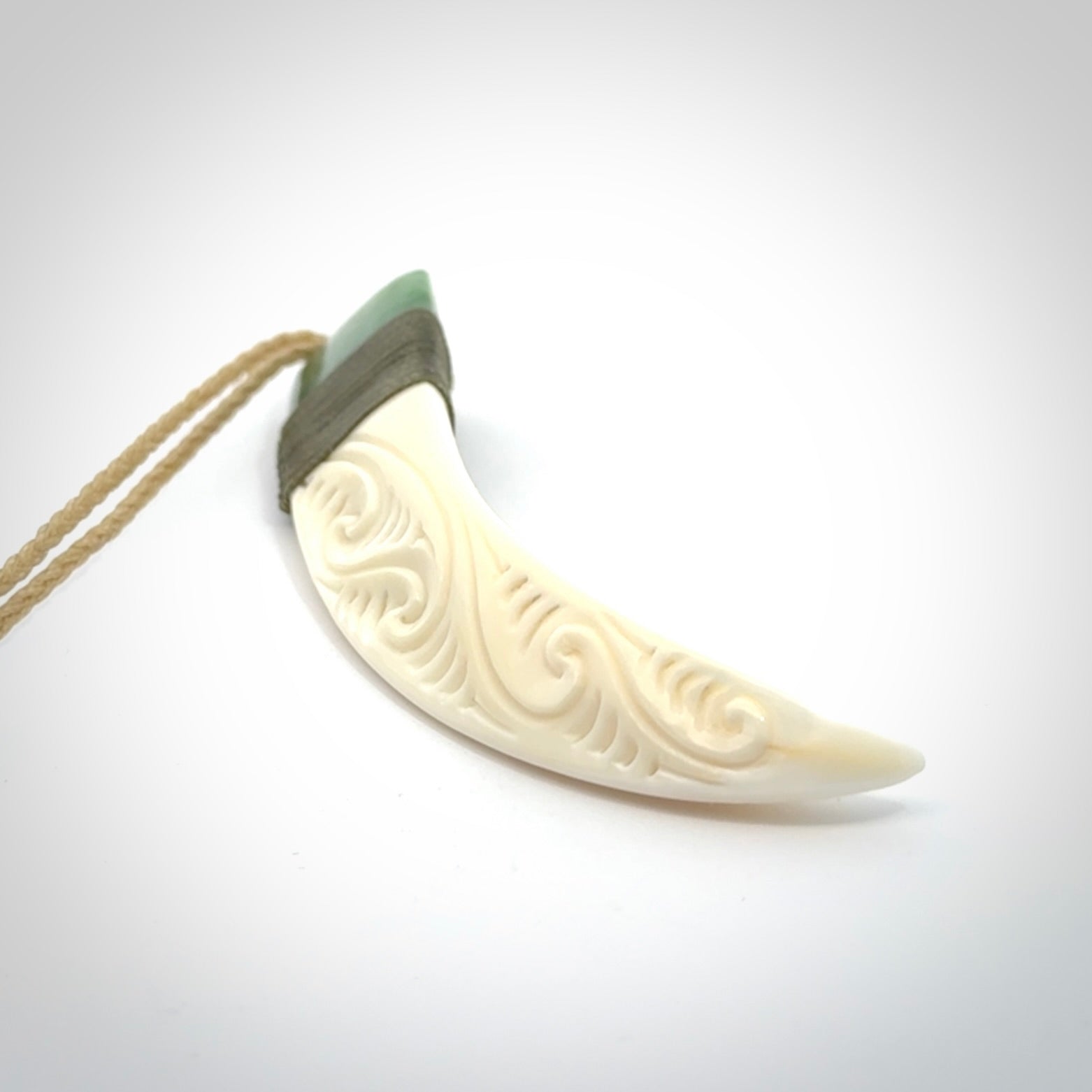 Boars Tusk Pendant with a jade cap. Hand made pendant carved from a boars tusk.